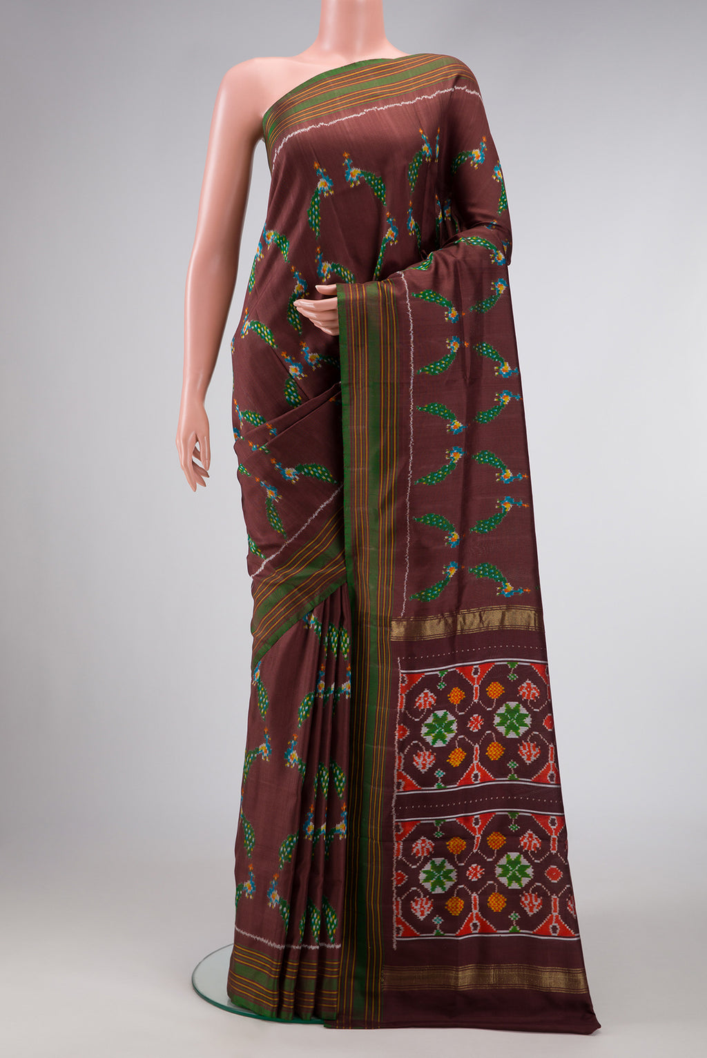 Brown Dual Tone Double Ikat Saree with Ikat Print on the body and Thread Border.  displayed on a mannequin