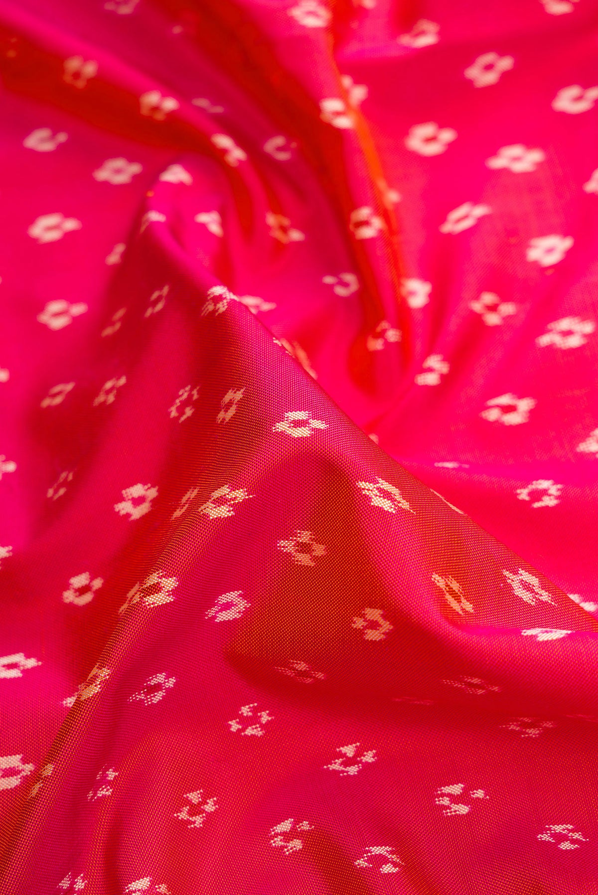 Close up of Pink Dual Tone Double Ikat Saree with Ikat Print on the body and Ikat Border.  displaying folds