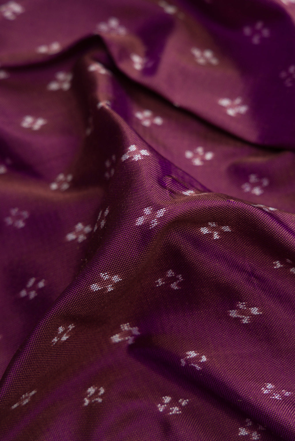 Close up of Purple Dual Tone Double Ikat Saree with Ikat Print on the body and Zari Border.  displaying folds