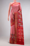 Red Dual Tone Double Ikat Saree with Ikat Print on the body and Zari Border.  displayed on a mannequin