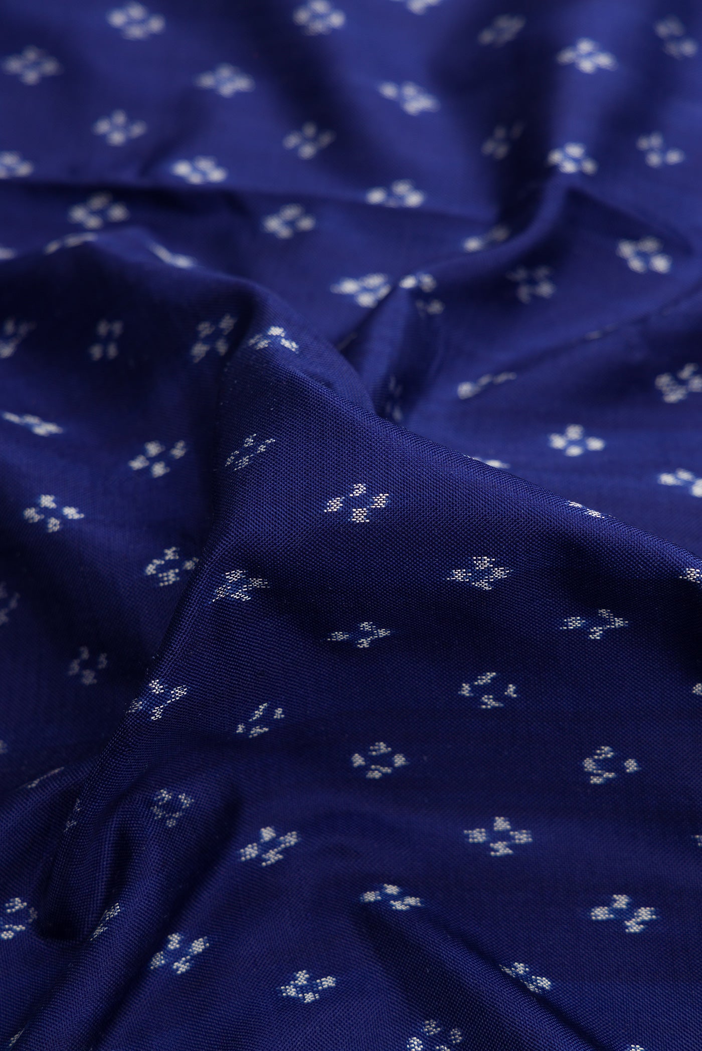 Close up of Navy Blue Dual Tone Double Ikat Saree with Ikat Print on the body and Ikat Border.  displaying folds