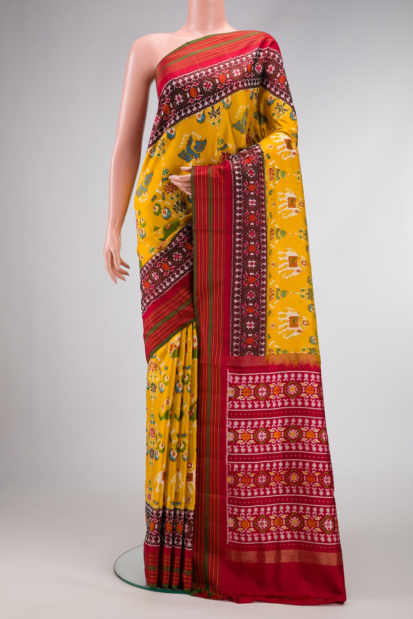 Mustard Dual Tone Double Ikat Saree with Ikat Print on the body and Ikat Border.  displayed on a mannequin