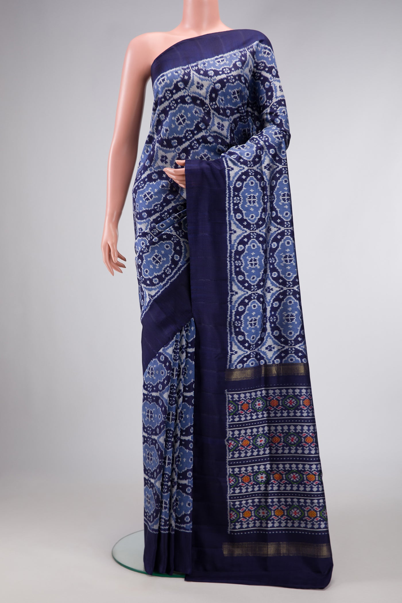 Navy Blue Dual Tone Double Ikat Saree with Ikat Print on the body and Plain Border.  displayed on a mannequin