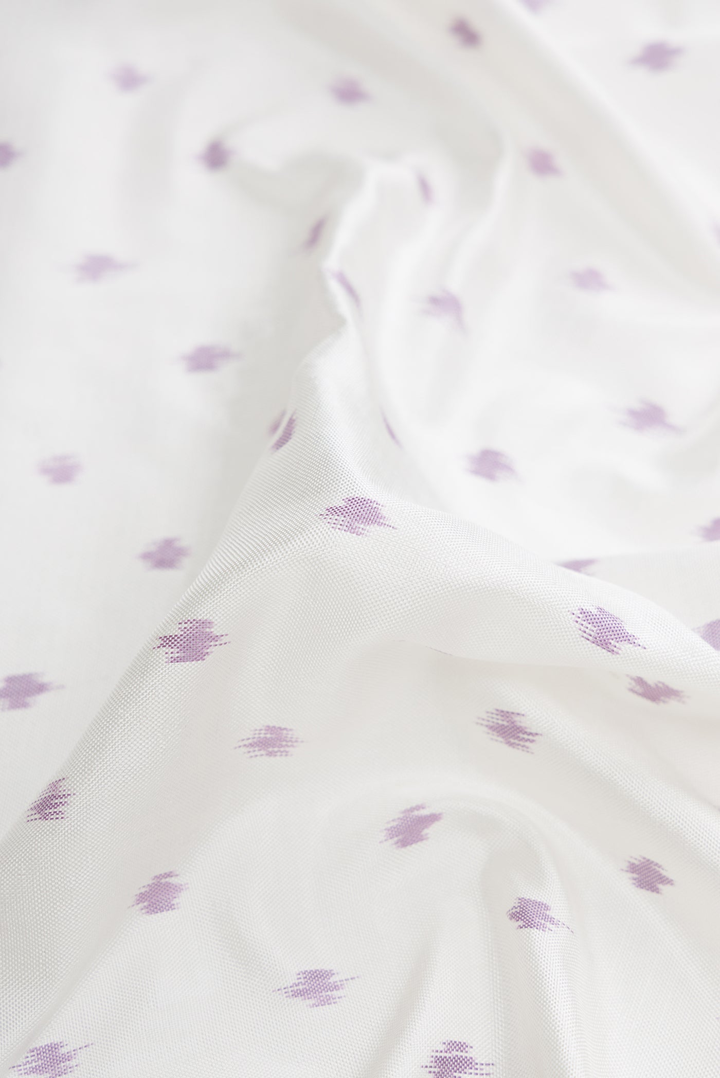 Close up of Off White Dual Tone Double Ikat Saree with Ikat Print on the body and Ikat Border.  displaying folds