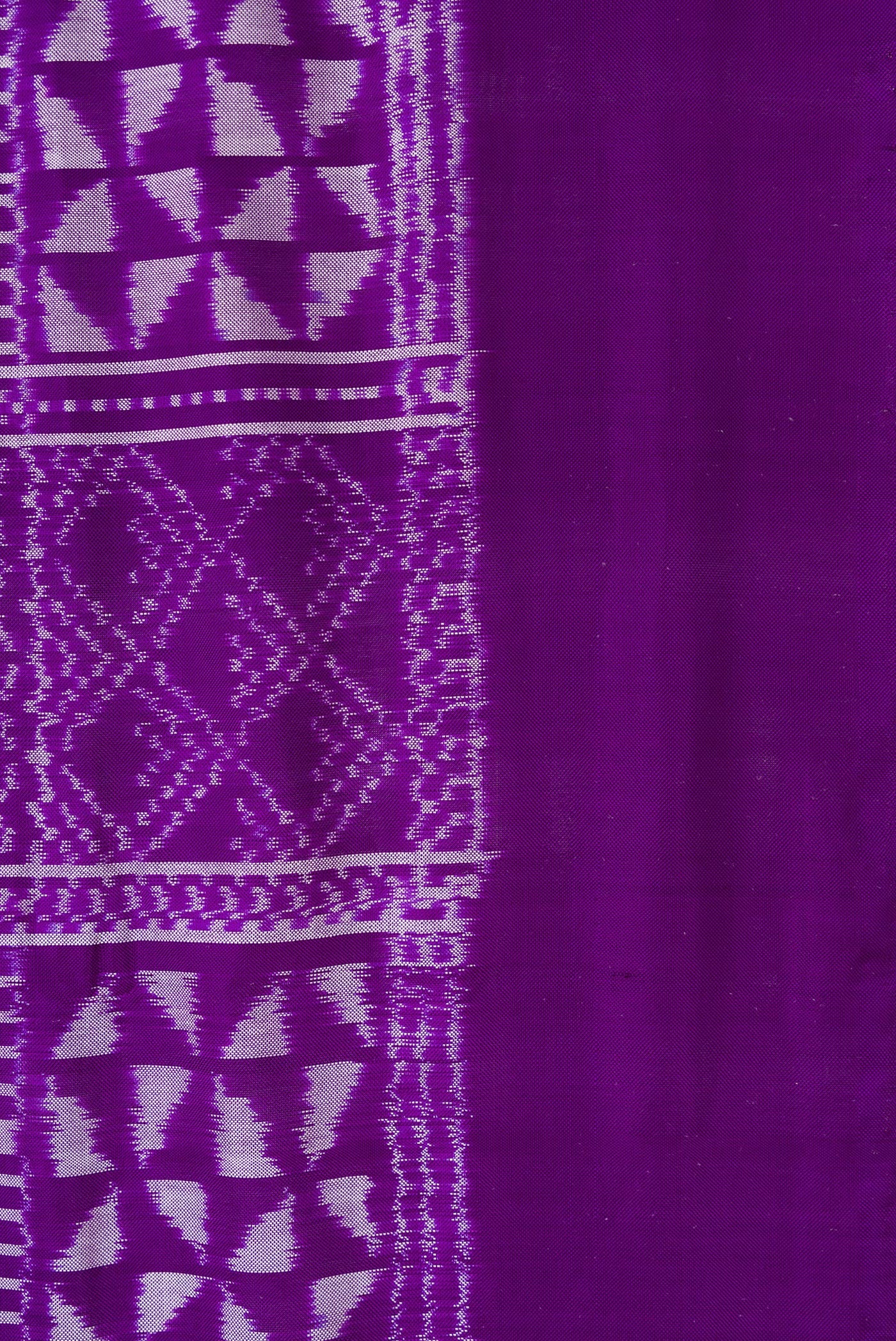 Border image of Violet Dual Tone Double Ikat Saree with Ikat Print on the body and Plain Border. 