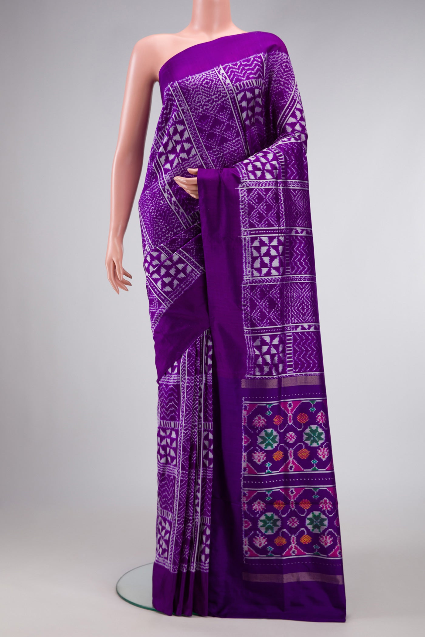 Violet Dual Tone Double Ikat Saree with Ikat Print on the body and Plain Border.  displayed on a mannequin
