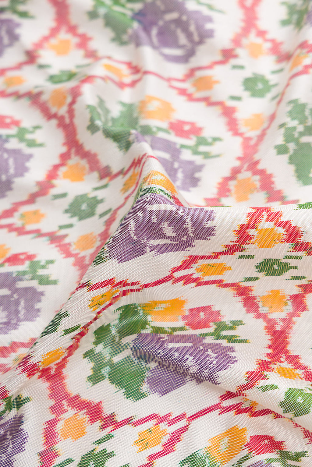 Close up of Off White Dual Tone Double Ikat Saree with Ikat Print on the body and Ikat Border.  displaying folds