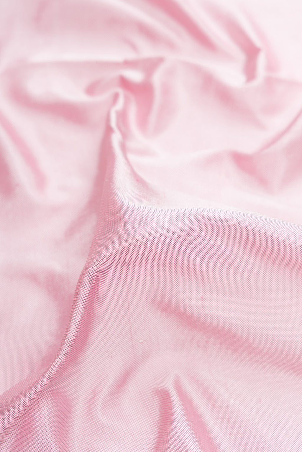Close up of Pink Dual Tone Double Ikat Saree with Plain Body and Ikat Border.  displaying folds