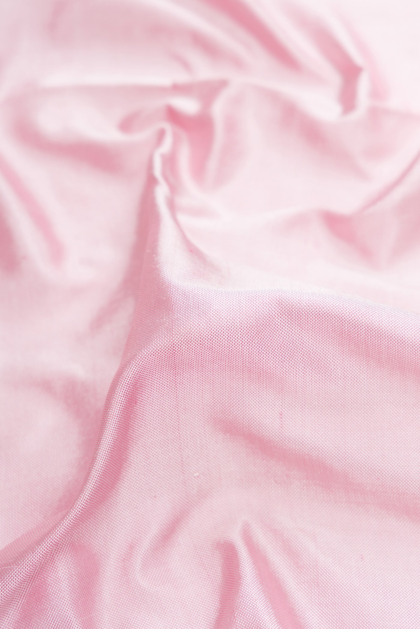 Close up of Pink Dual Tone Double Ikat Saree with Plain Body and Ikat Border.  displaying folds