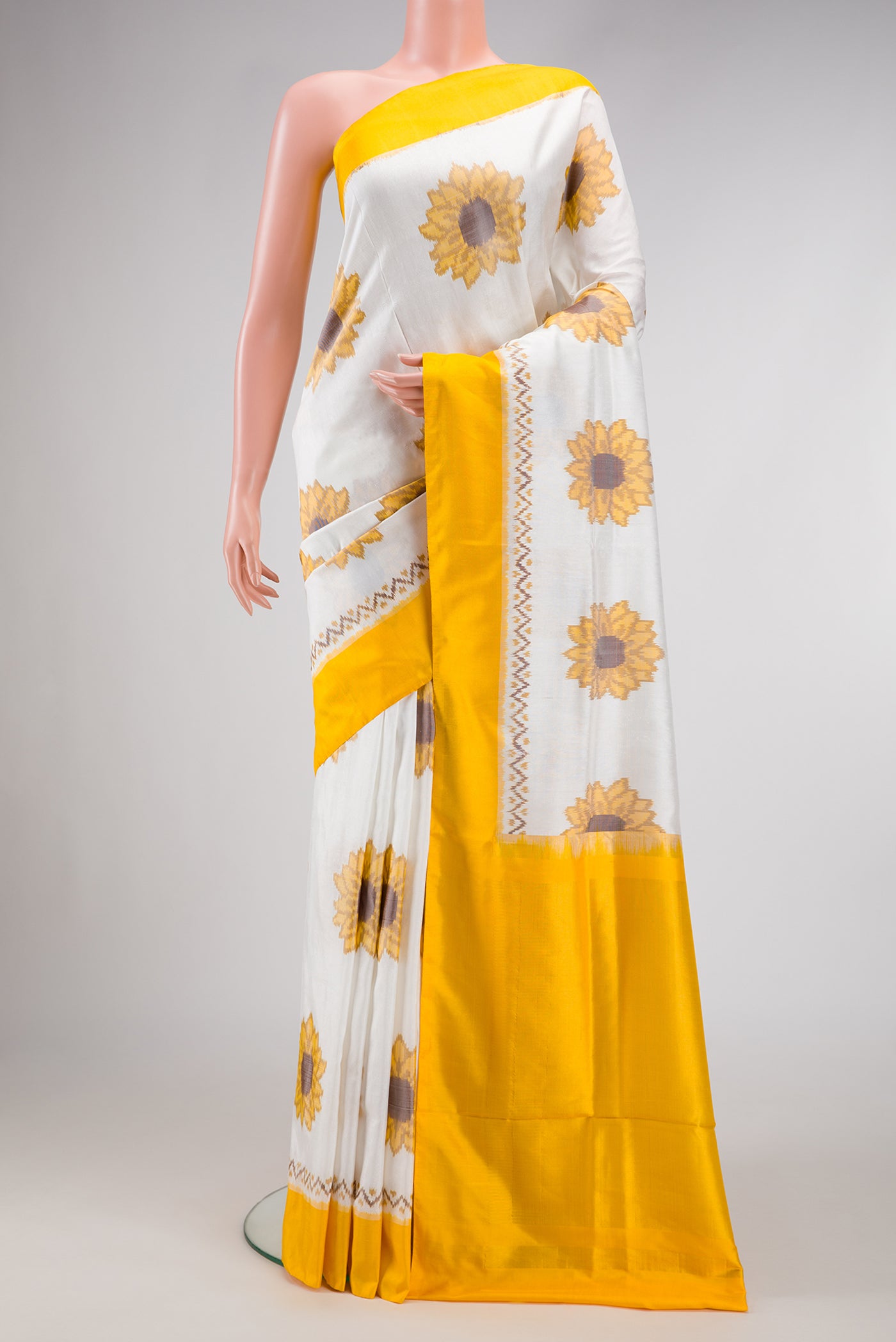 Off White Dual Tone Double Ikat Saree with Ikat Print on the body and Plain Border.  displayed on a mannequin
