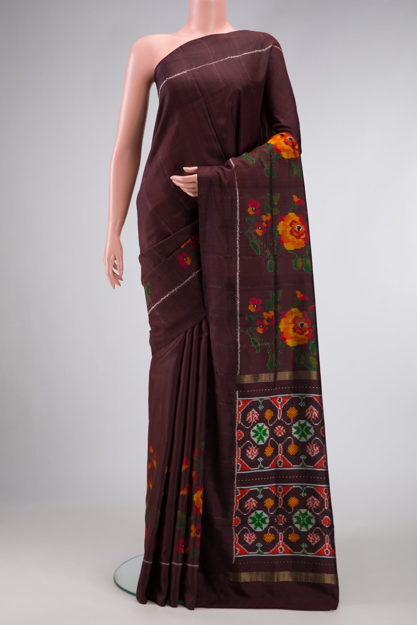 Brown Dual Tone Double Ikat Saree with Plain Body and Ikat Border.  displayed on a mannequin