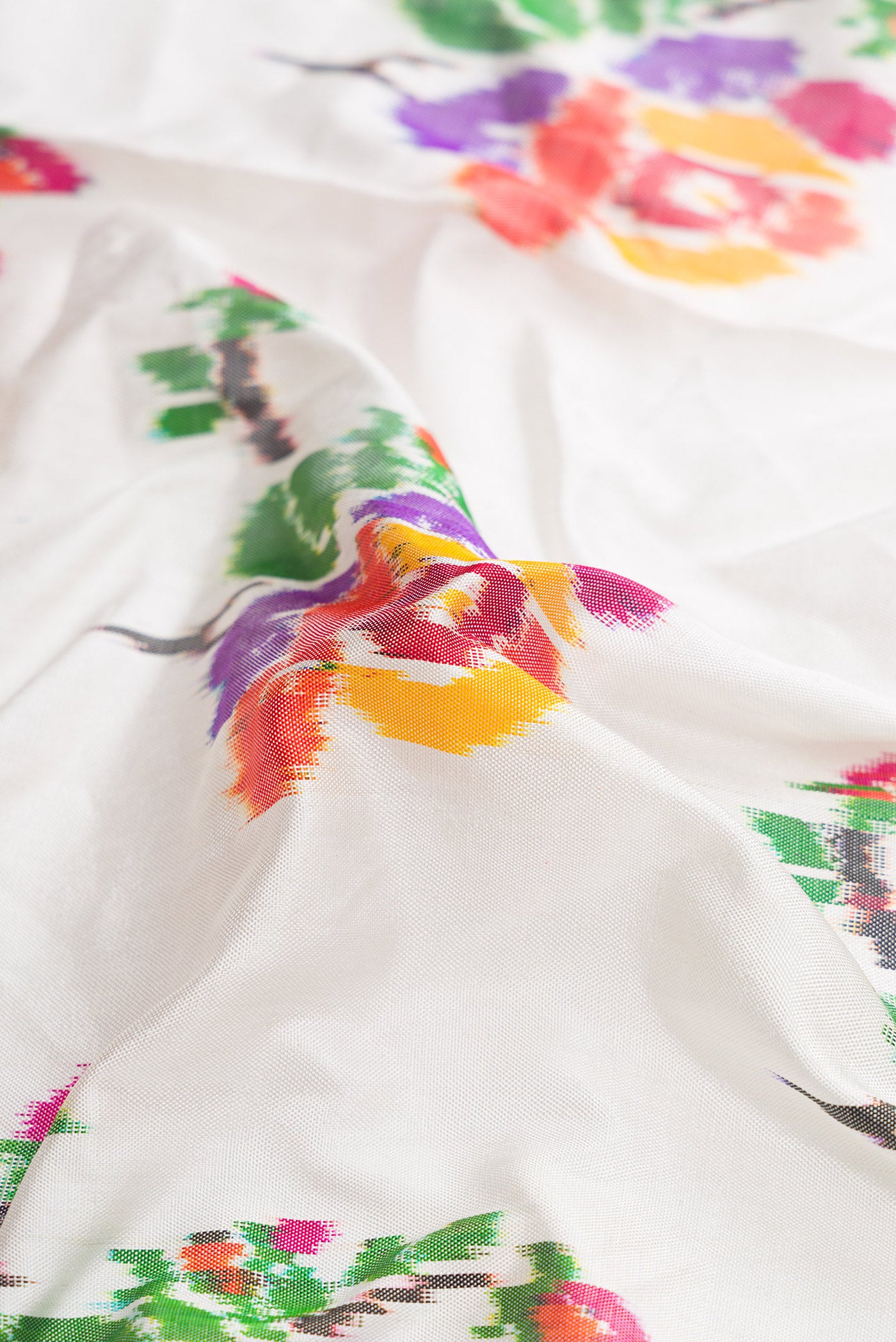 Close up of Off White Dual Tone Double Ikat Saree with Ikat Print on the body and Zari Border.  displaying folds
