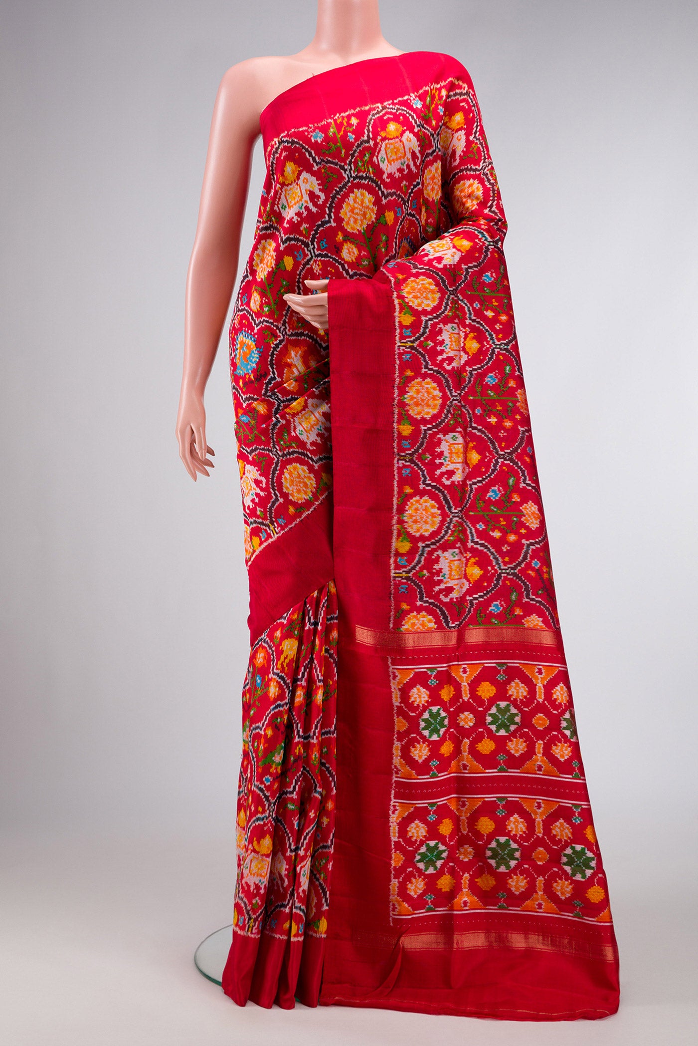 Red Dual Tone Double Ikat Saree with Ikat Print on the body and Plain Border.  displayed on a mannequin