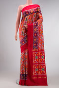 Brick Orange Dual Tone Double Ikat Saree with Ikat Print on the body and Ikat Border.  displayed on a mannequin