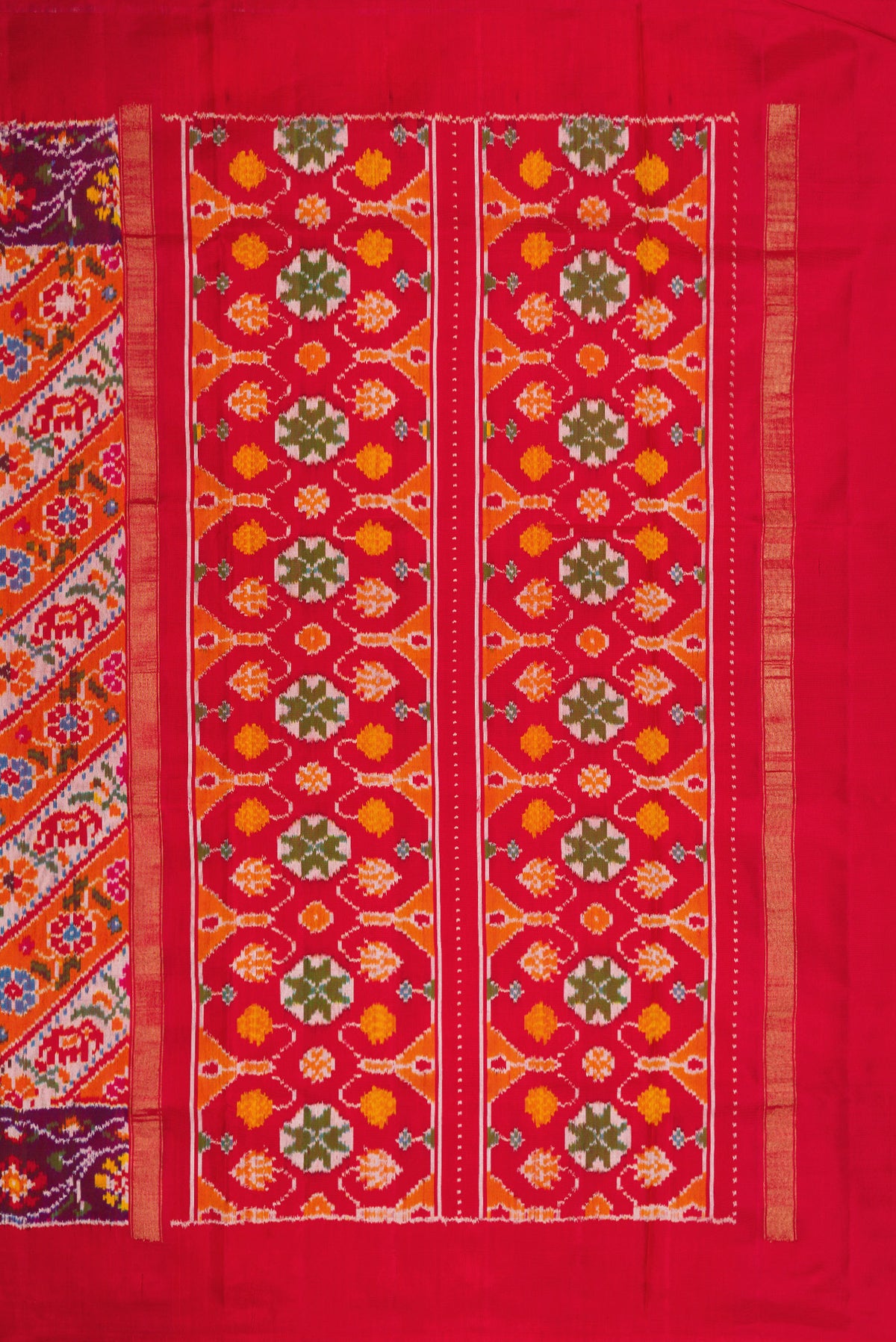 Close up image of the pallu of Brick Orange Dual Tone Double Ikat Saree with Ikat Print on the body and Ikat Border. 