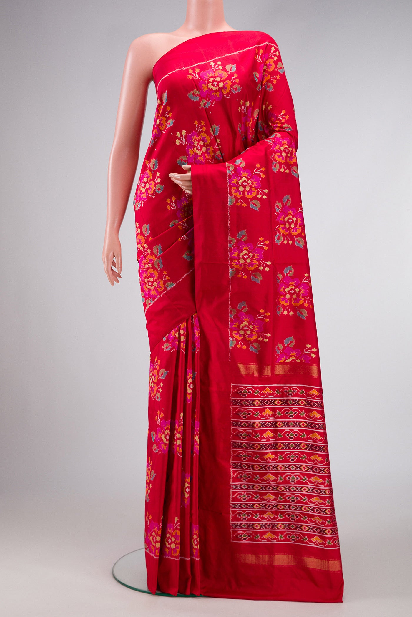Red Dual Tone Double Ikat Saree with Ikat Print on the body and Zari Border.  displayed on a mannequin