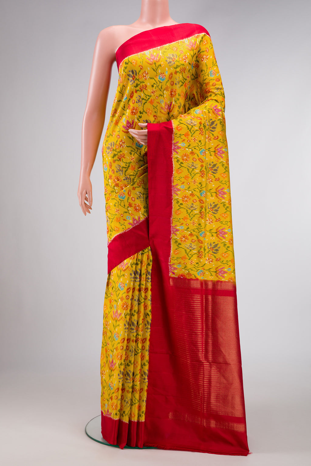 Yellow Dual Tone Double Ikat Saree with Ikat Print on the body and Plain Border.  displayed on a mannequin