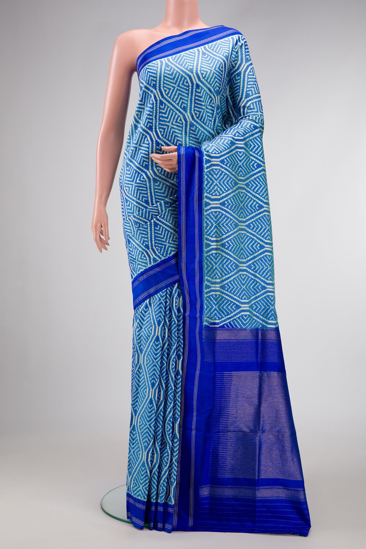 Sky Blue Dual Tone Double Ikat Saree with Ikat Print on the body and Thread Border.  displayed on a mannequin