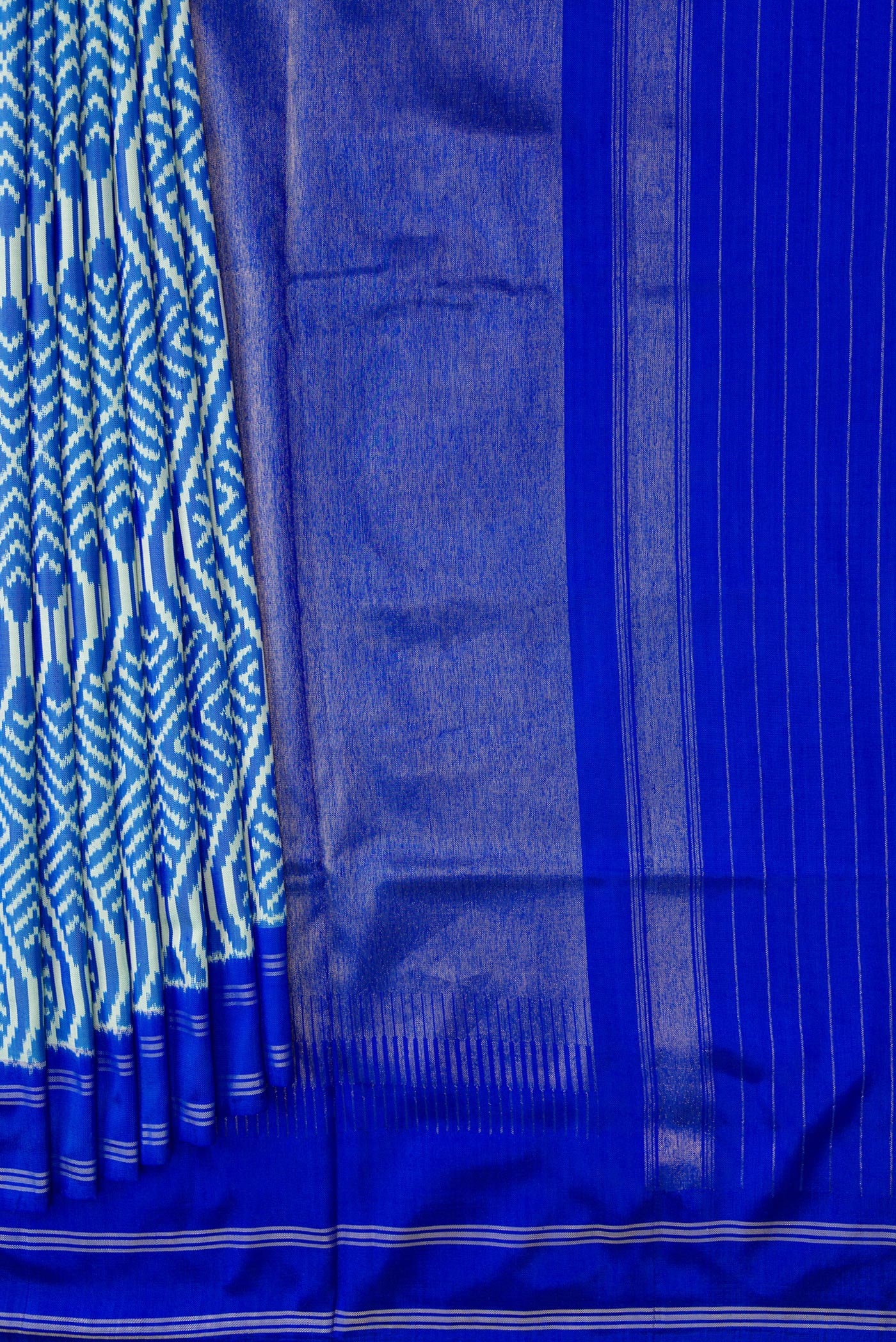Pleats and pallu of Sky Blue Dual Tone Double Ikat Saree with Ikat Print on the body and Thread Border. 