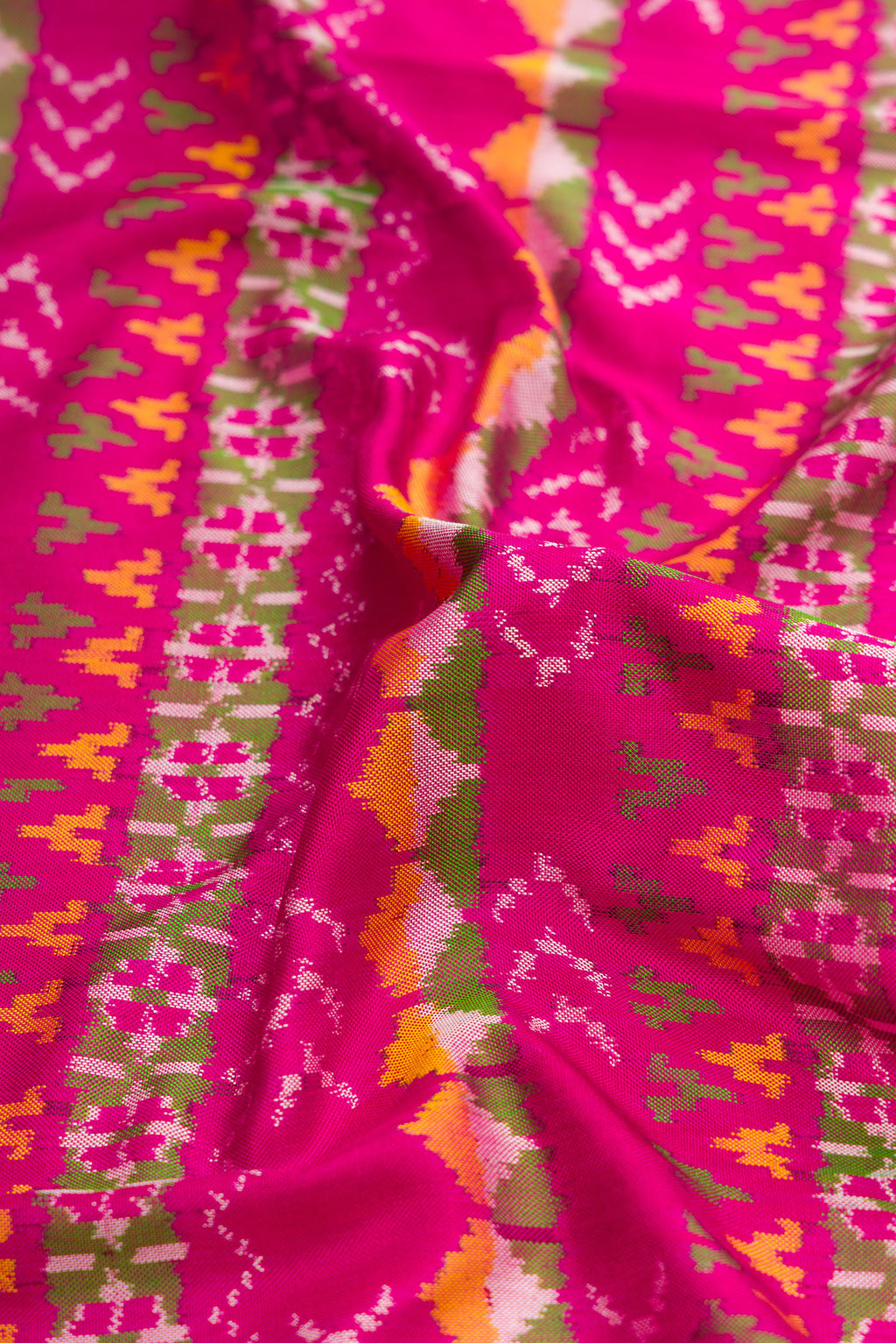 Close up of Pink Dual Tone Double Ikat Saree with Ikat Print on the body and Ikat Border.  displaying folds
