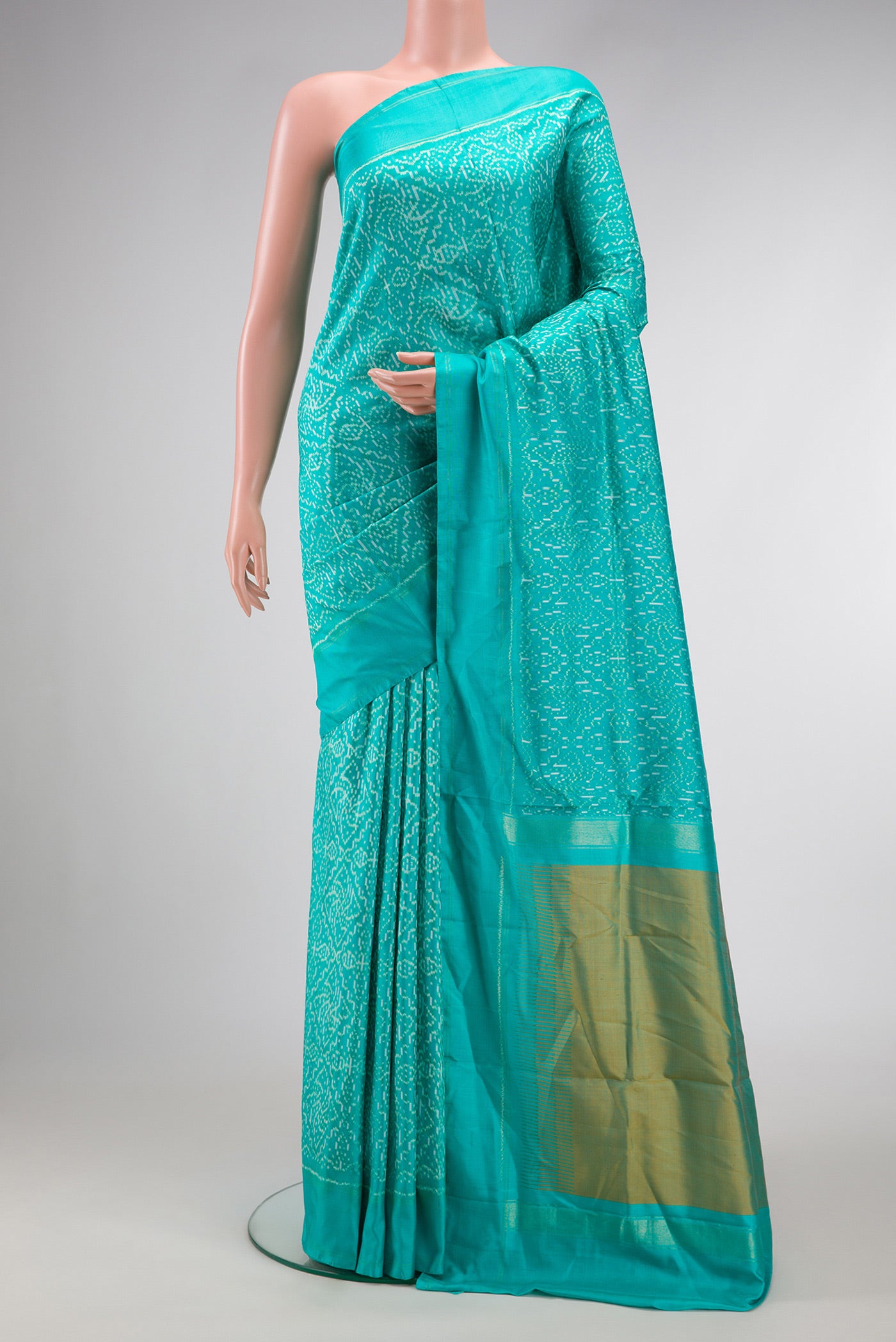 Sea Green Dual Tone Double Ikat Saree with Ikat Print on the body and Zari Border.  displayed on a mannequin