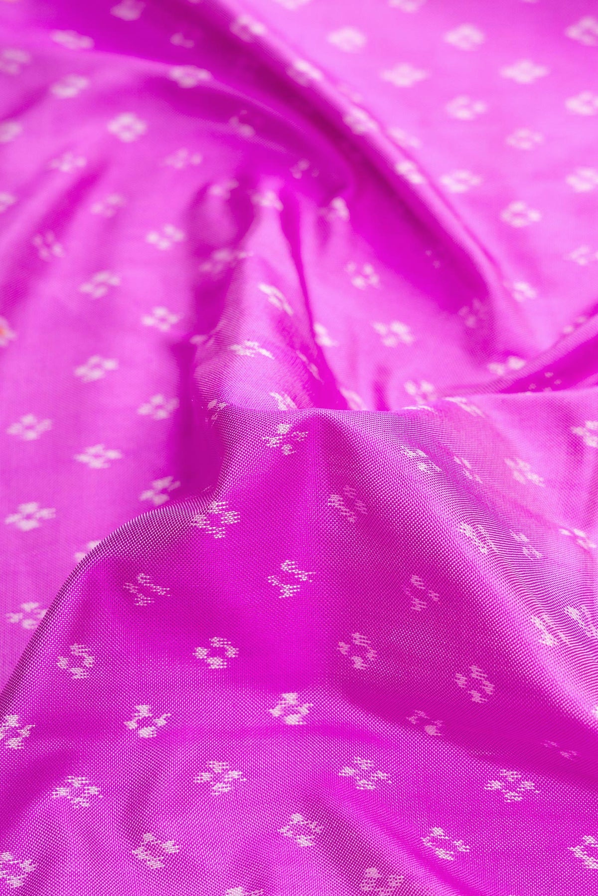 Close up of Pink Dual Tone Double Ikat Saree with Ikat Print on the body and Ikat Border.  displaying folds