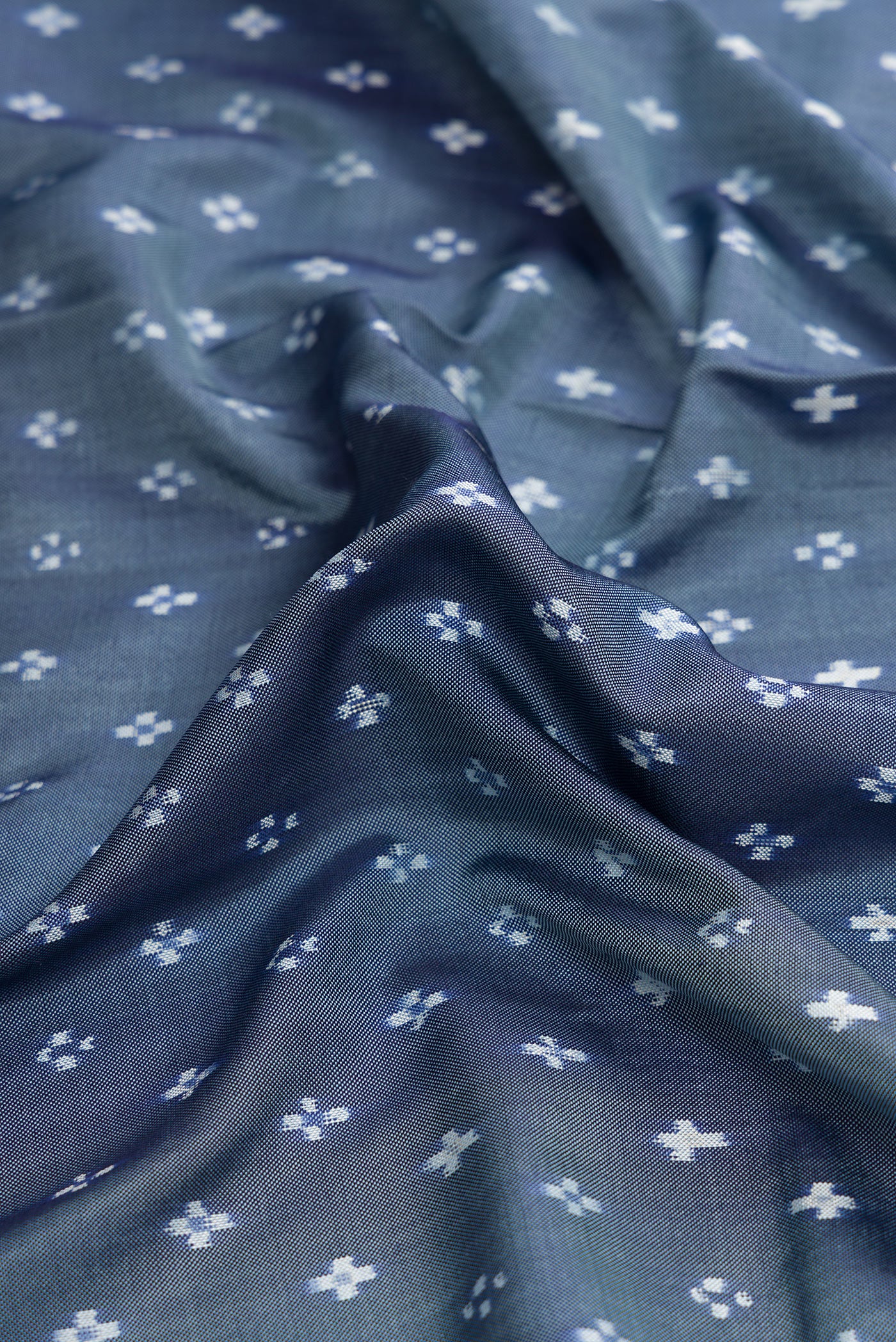 Close up of Grey Dual Tone Double Ikat Saree with Ikat Print on the body and Ikat Border.  displaying folds