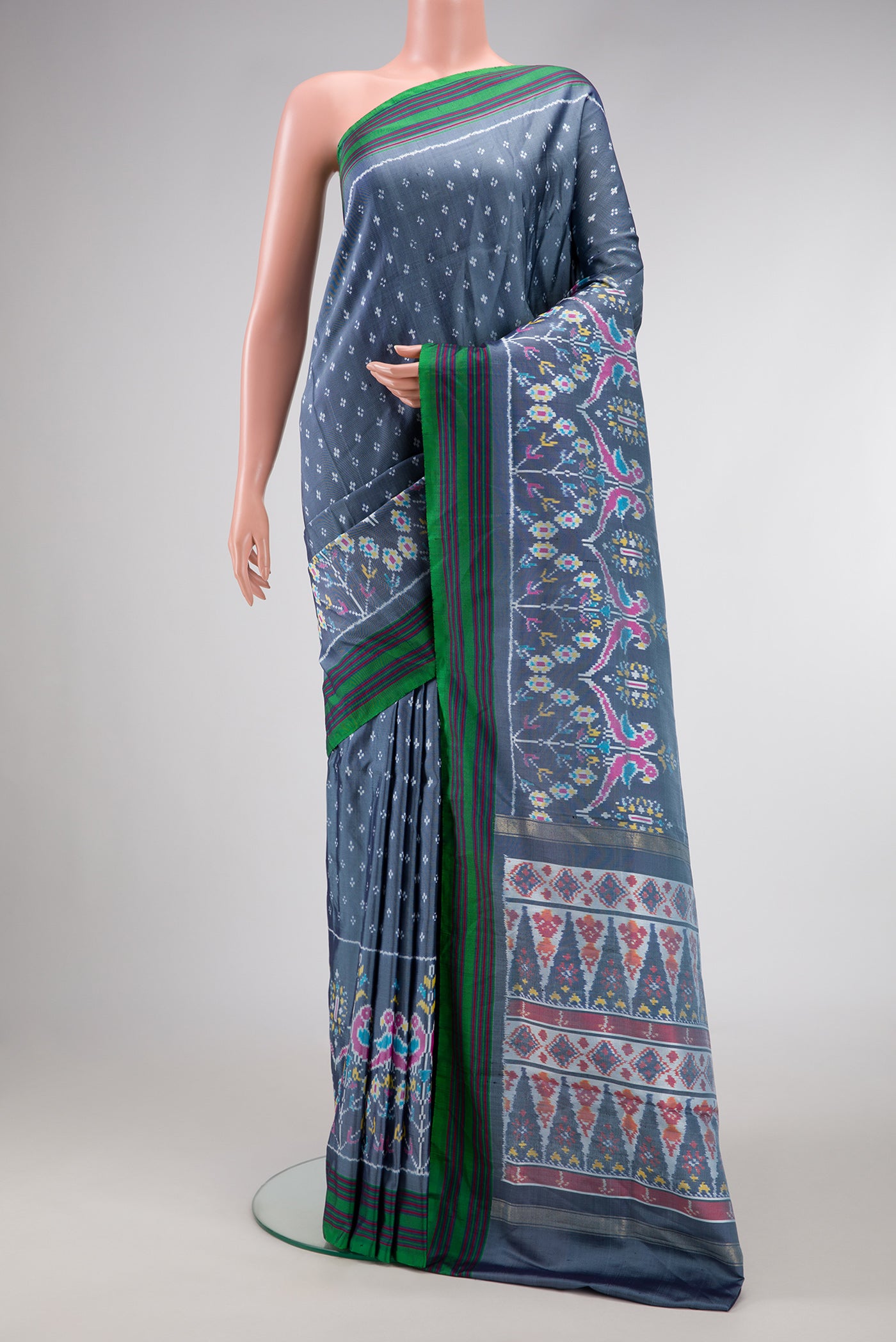 Grey Dual Tone Double Ikat Saree with Ikat Print on the body and Ikat Border.  displayed on a mannequin