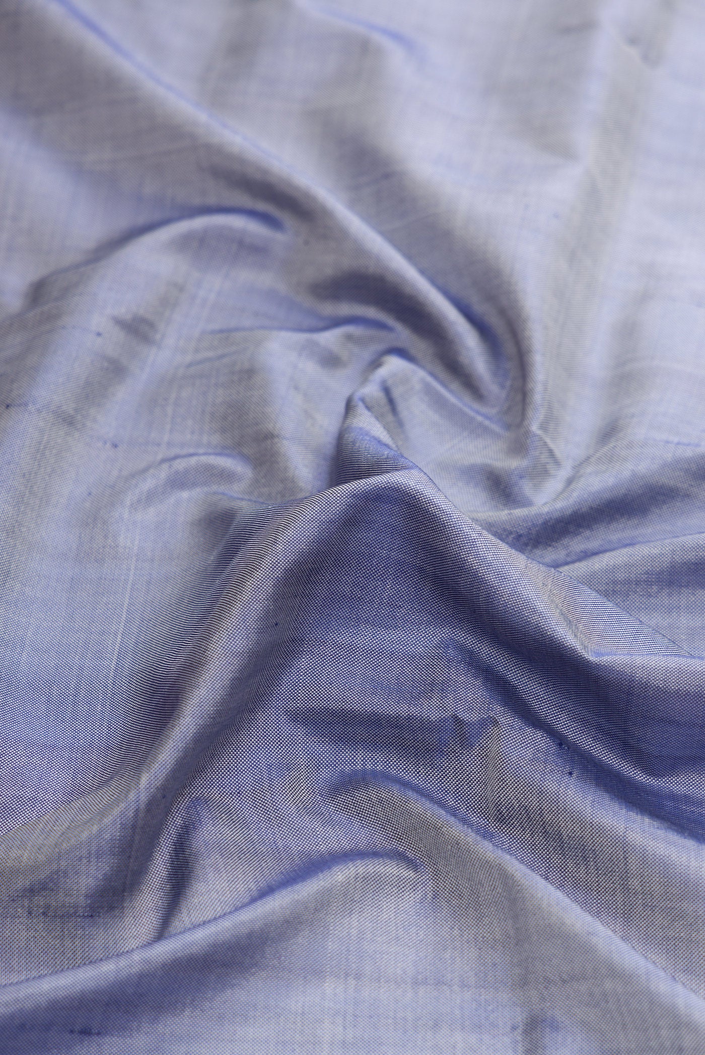 Close up of Grey Dual Tone Double Ikat Saree with Plain Body and Fancy Border.  displaying folds