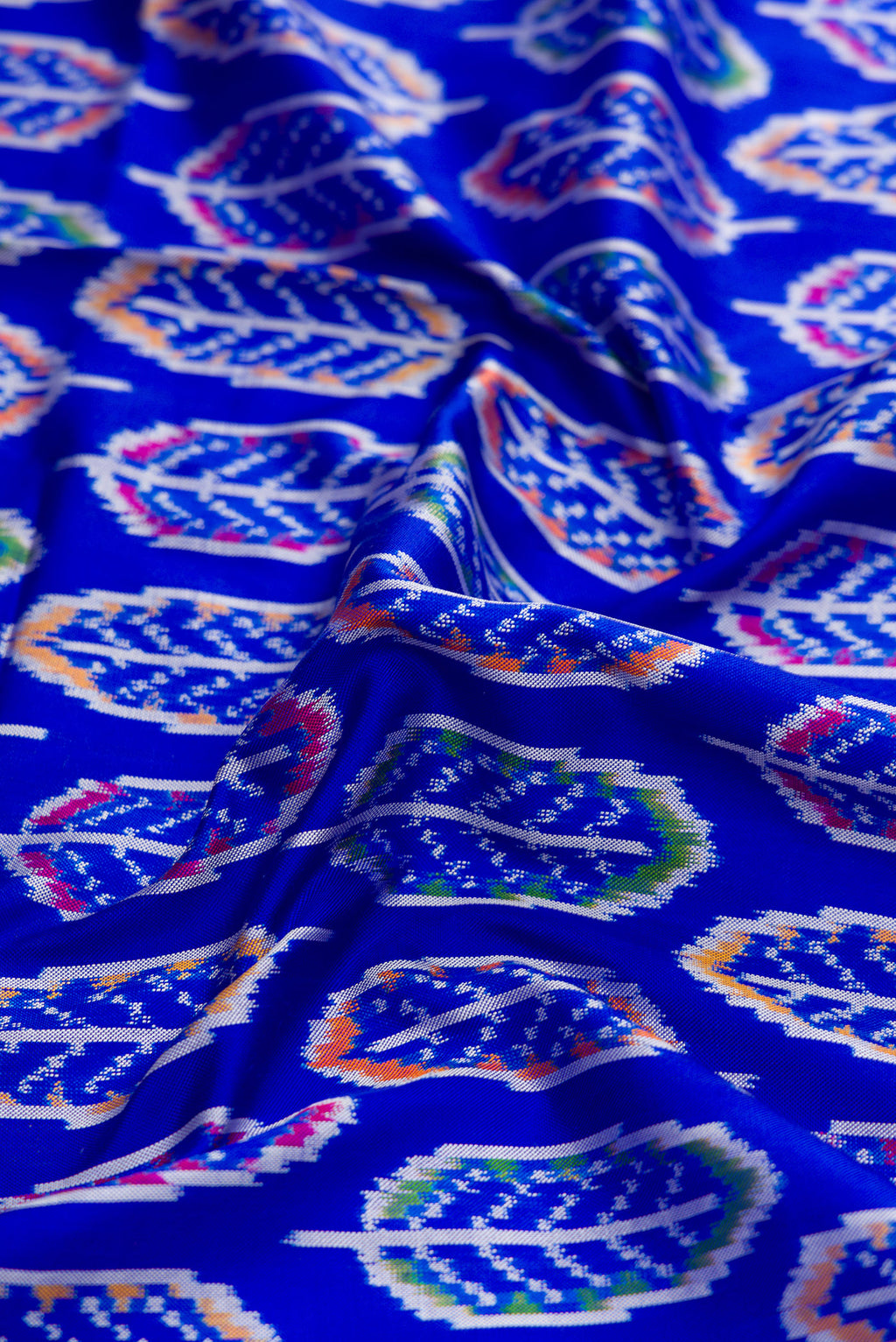 Close up of Royal Blue Dual Tone Double Ikat Saree with Ikat Print on the body and Thread Border.  displaying folds