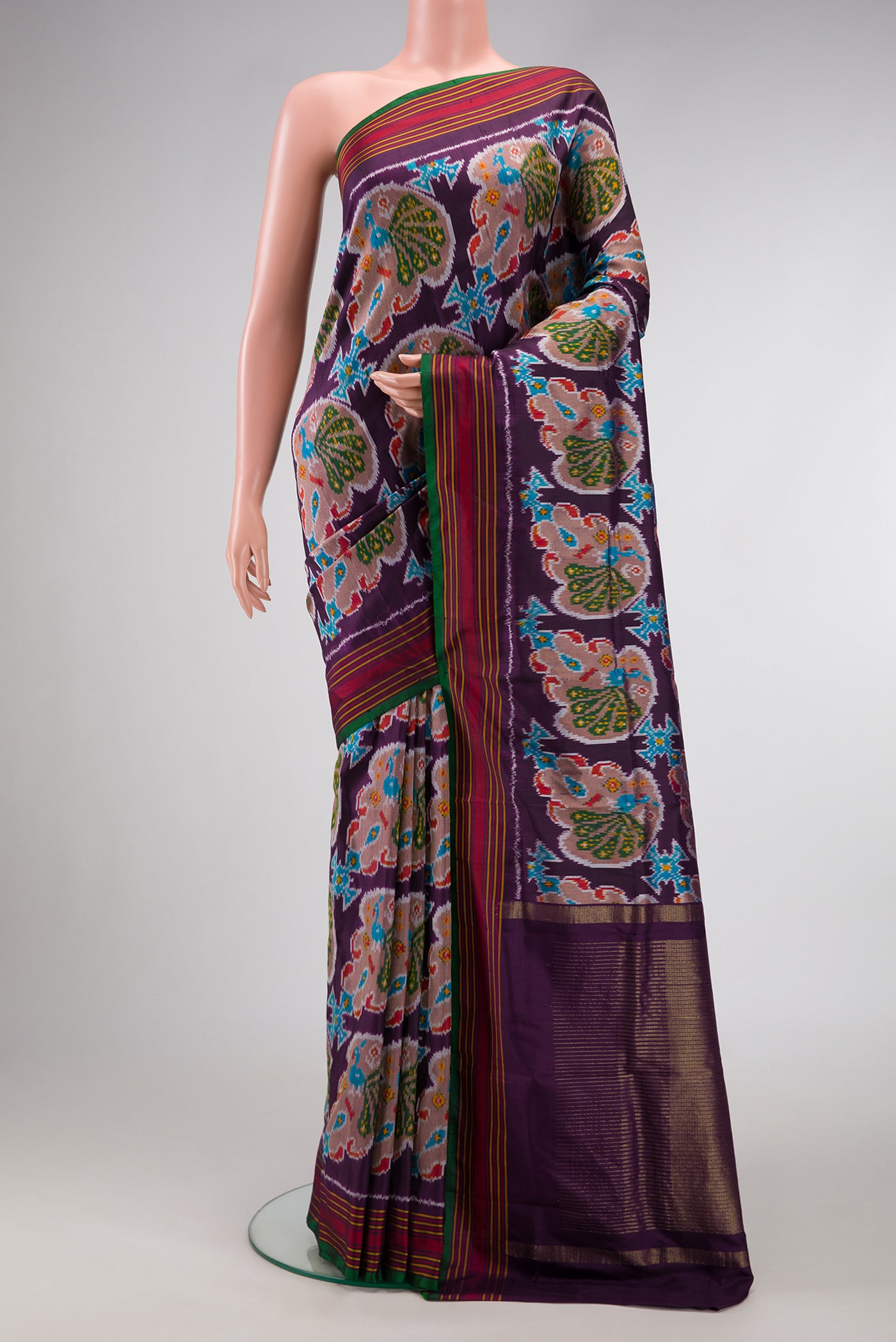 Burgundy Dual Tone Double Ikat Saree with Ikat Print on the body and Thread Border.  displayed on a mannequin