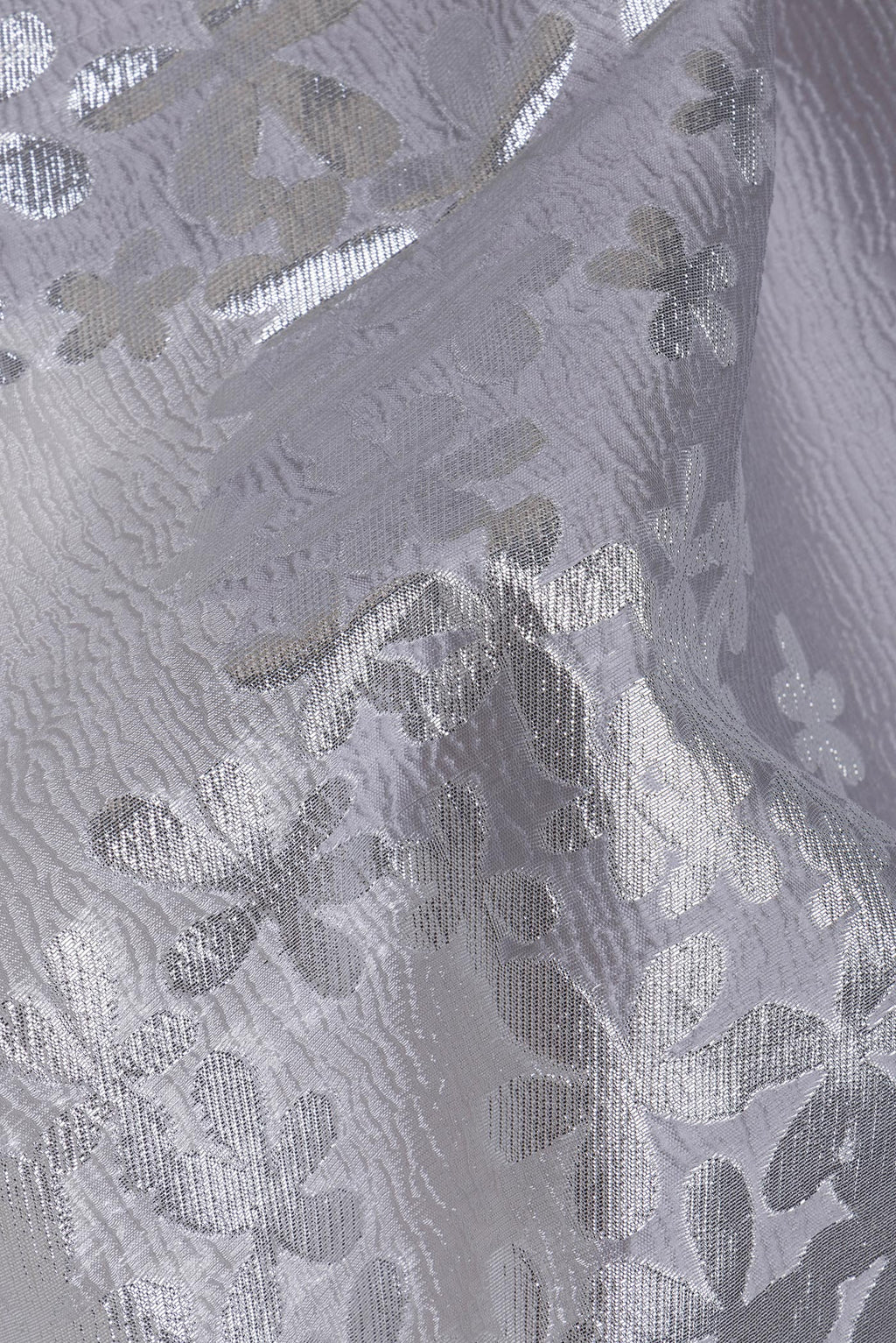 Close up of Silver Organza Silk Saree with Zari Brocade on the body and Embroidery Border.  displaying folds