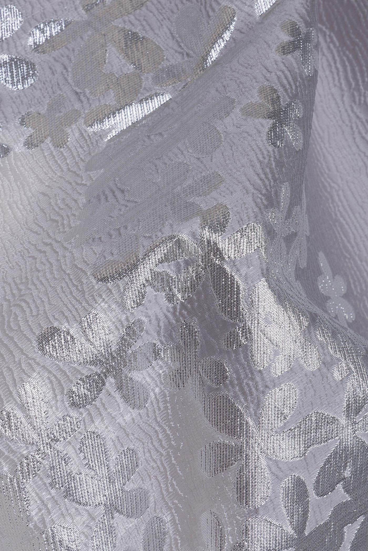 Close up of Silver Organza Silk Saree with Zari Brocade on the body and Embroidery Border.  displaying folds