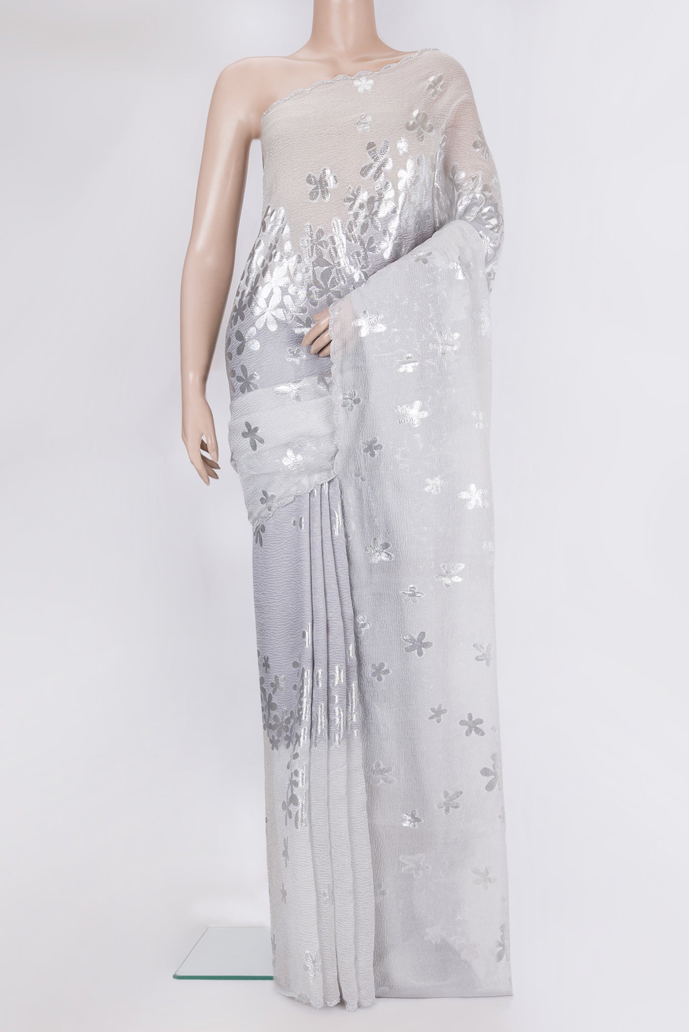 Silver Organza Silk Saree with Zari Brocade on the body and Embroidery Border.  displayed on a mannequin