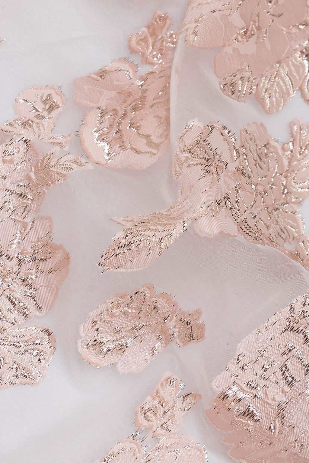 Close up of Peach Organza Saree with Embroidery on the body and Embroidery Border.  displaying folds