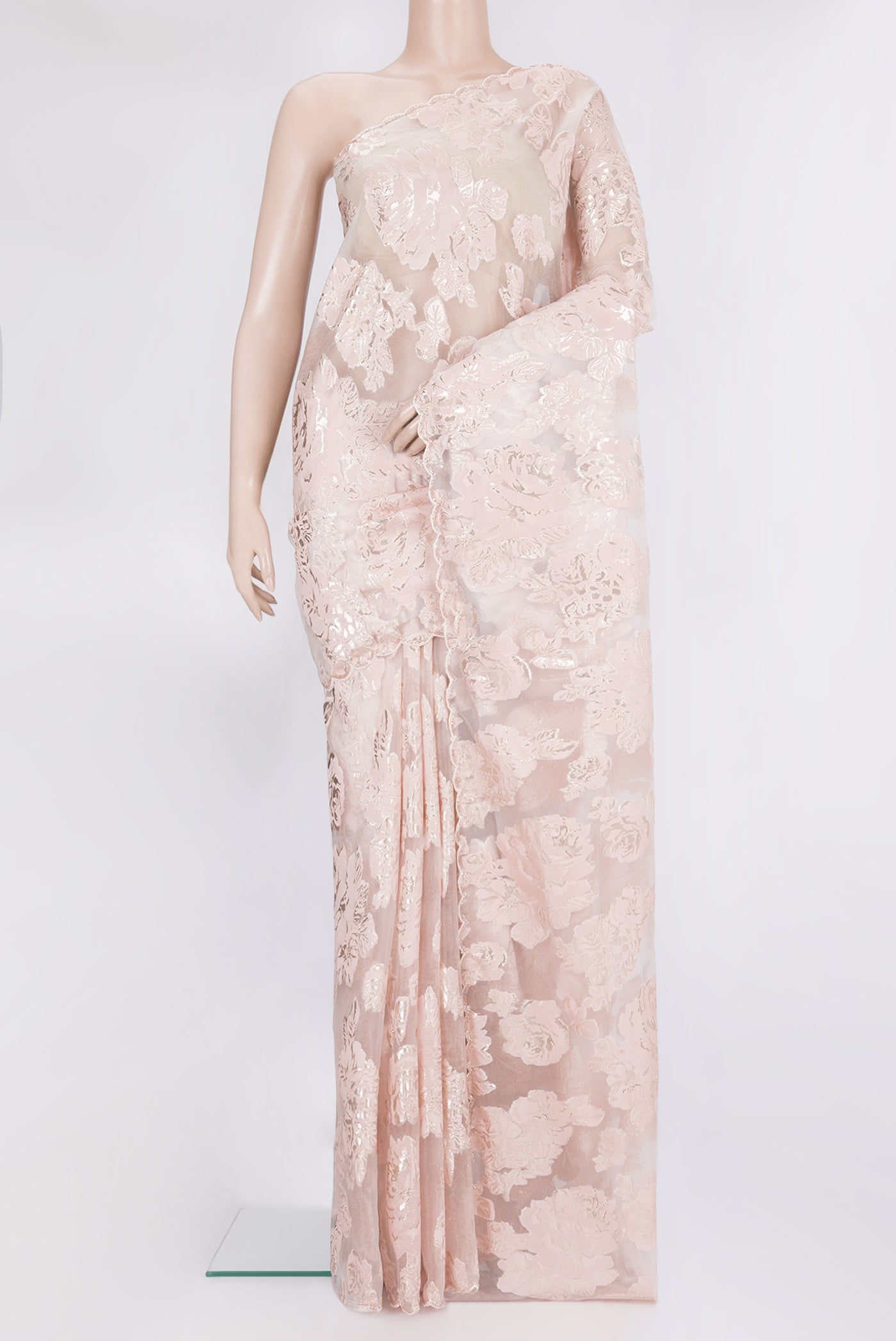 Peach Organza Saree with Embroidery on the body and Embroidery Border.  displayed on a mannequin
