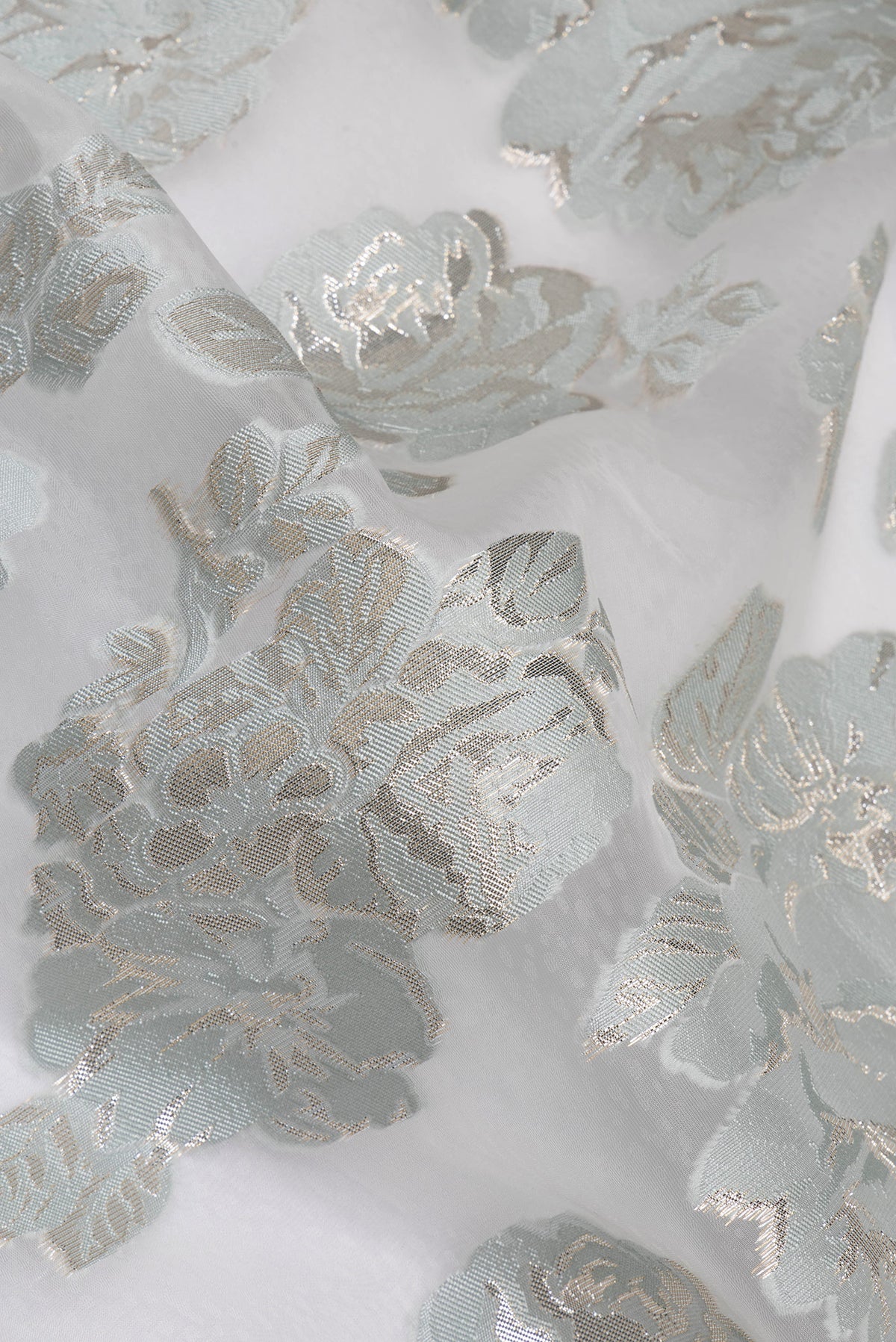 Close up of Blue Grey Dual Tone Organza Saree with Embroidery on the body and Embroidery Border.  displaying folds