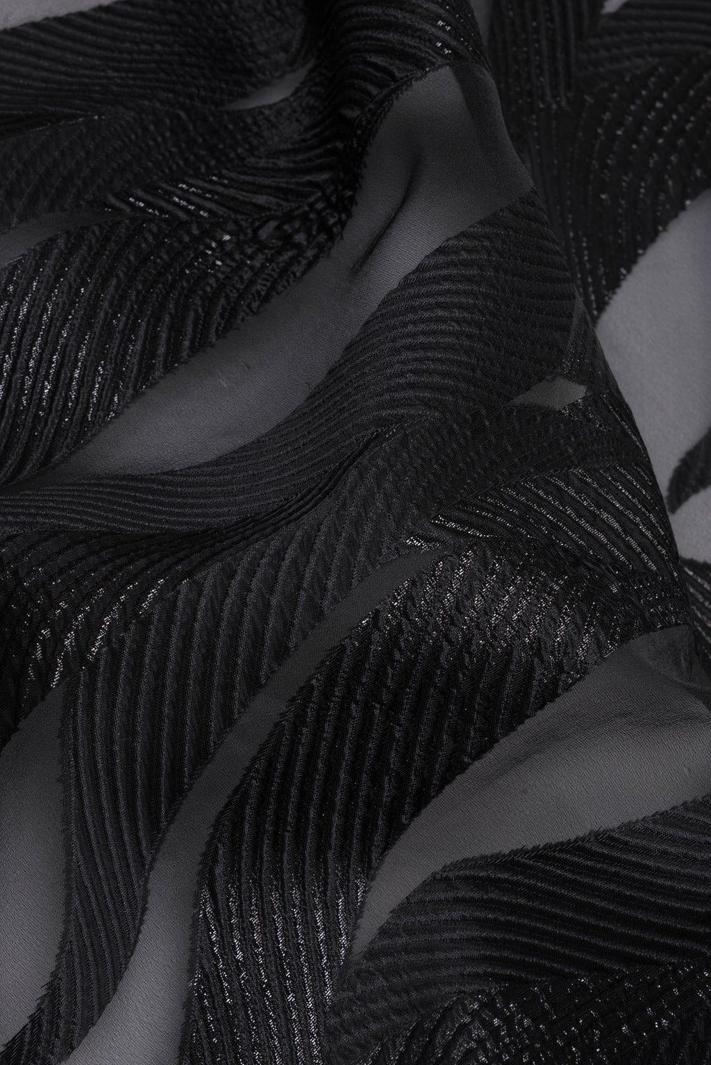 Close up of Black Organza Saree with Embroidery on the body and Embroidery Border.  displaying folds