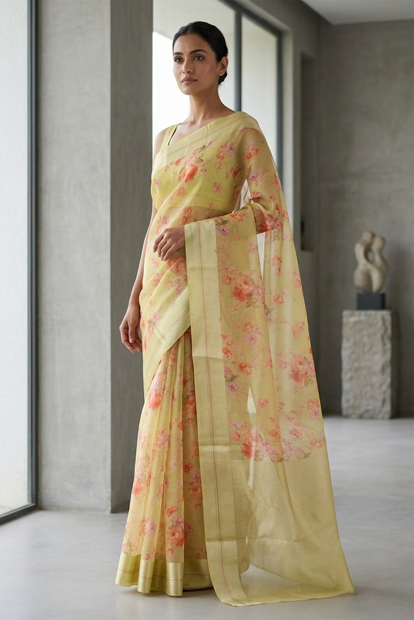 Model wearing a Beige Organza Silk Saree with Floral Print on the body and Satin Border.