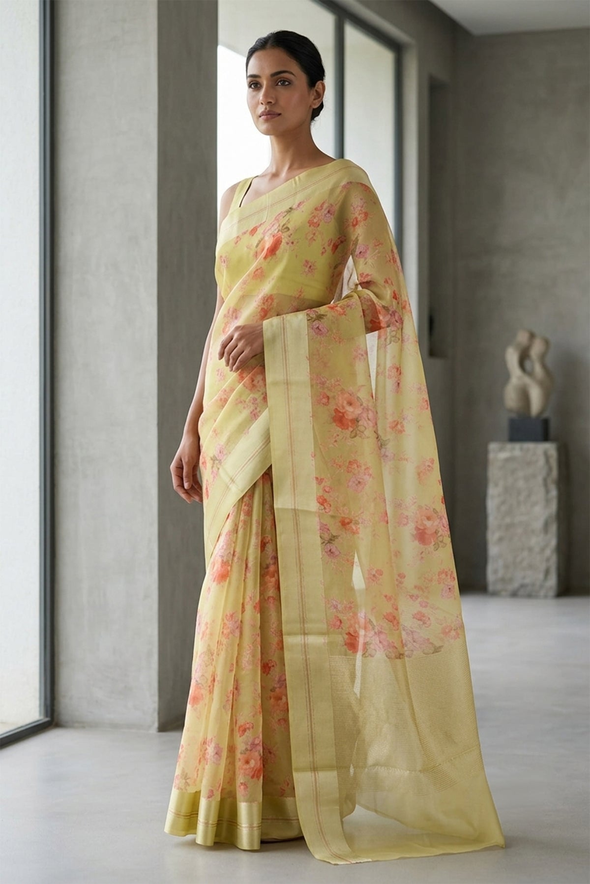 Model wearing a Beige Organza Silk Saree with Floral Print on the body and Satin Border.