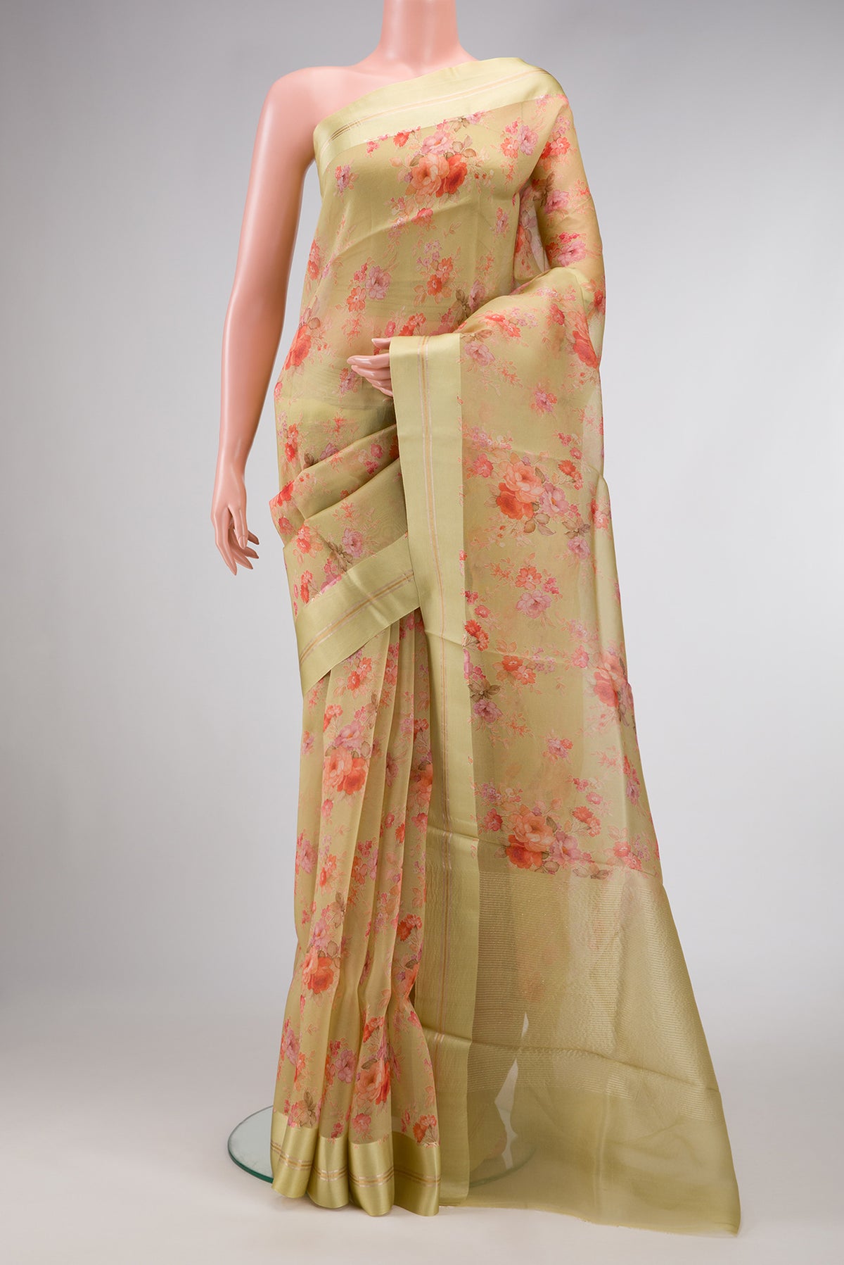 Pista Green Dual Tone Organza Silk Saree with Printed design on the body and Zari And Thread Border.  displayed on a mannequin