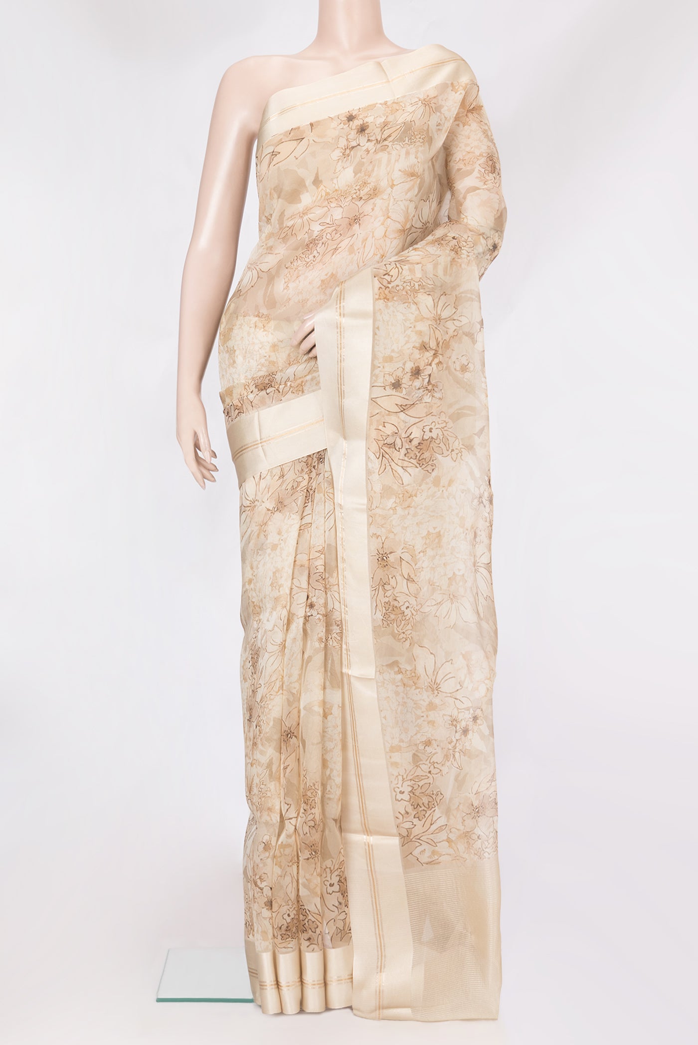 Beige Organza Silk Saree with Floral Print on the body and Satin Border.  displayed on a mannequin