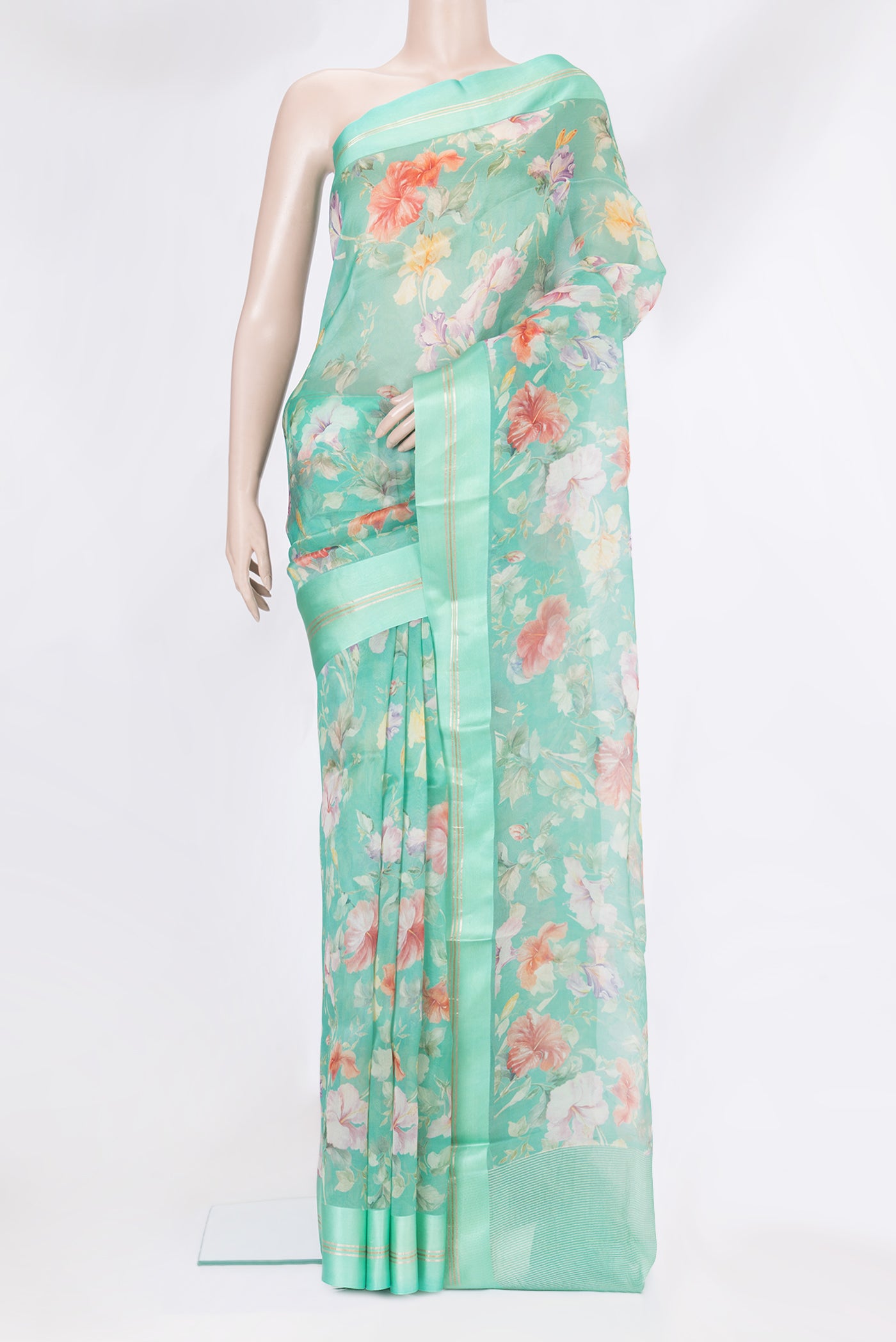 Turquoise Organza Silk Saree with Floral Print on the body and Plain Border.  displayed on a mannequin