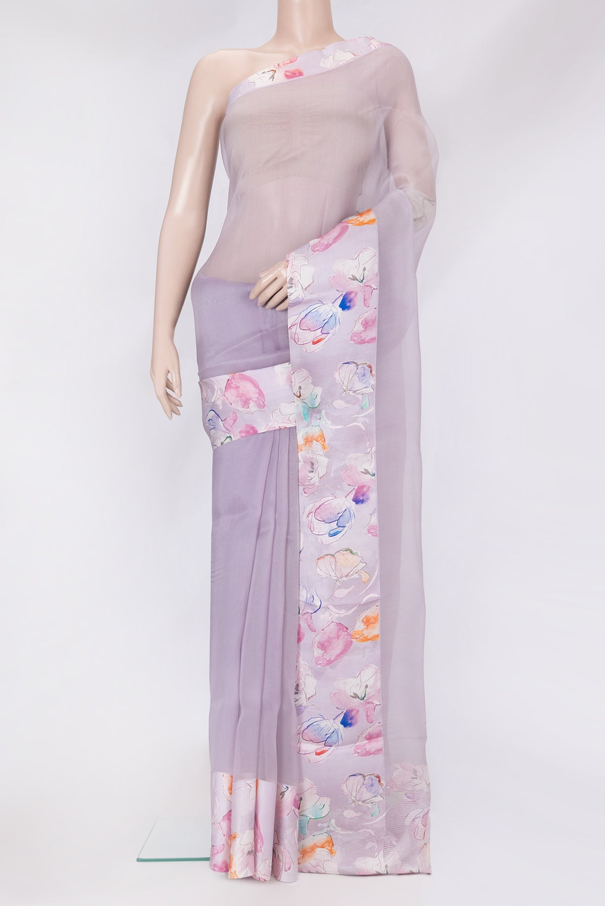 Lavender Organza Silk Saree with Plain Body and Printed Border.  displayed on a mannequin