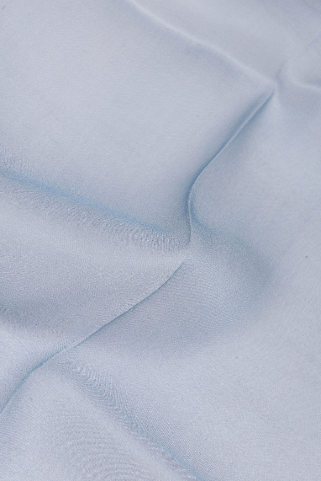 Close up of Blue Organza Silk Saree with Plain Body and Printed Border.  displaying folds