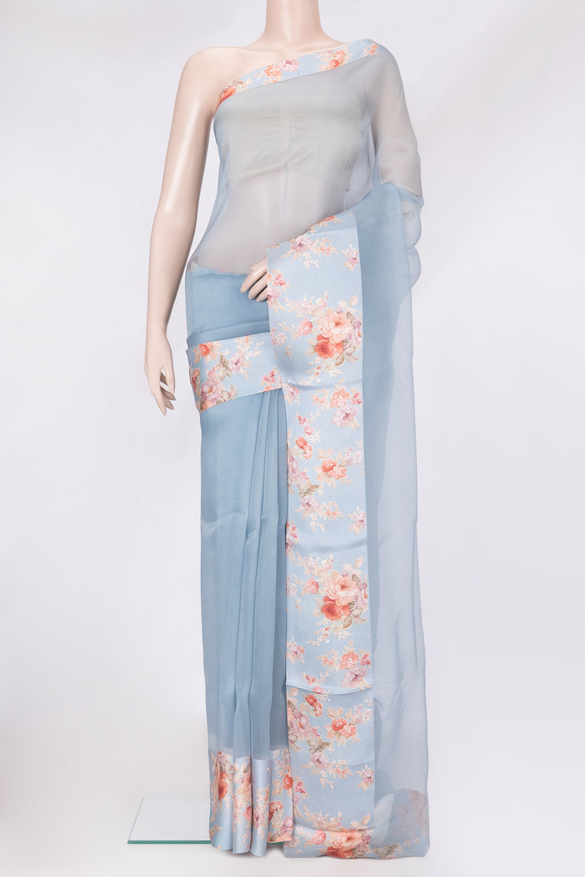 Blue Organza Silk Saree with Plain Body and Printed Border.  displayed on a mannequin
