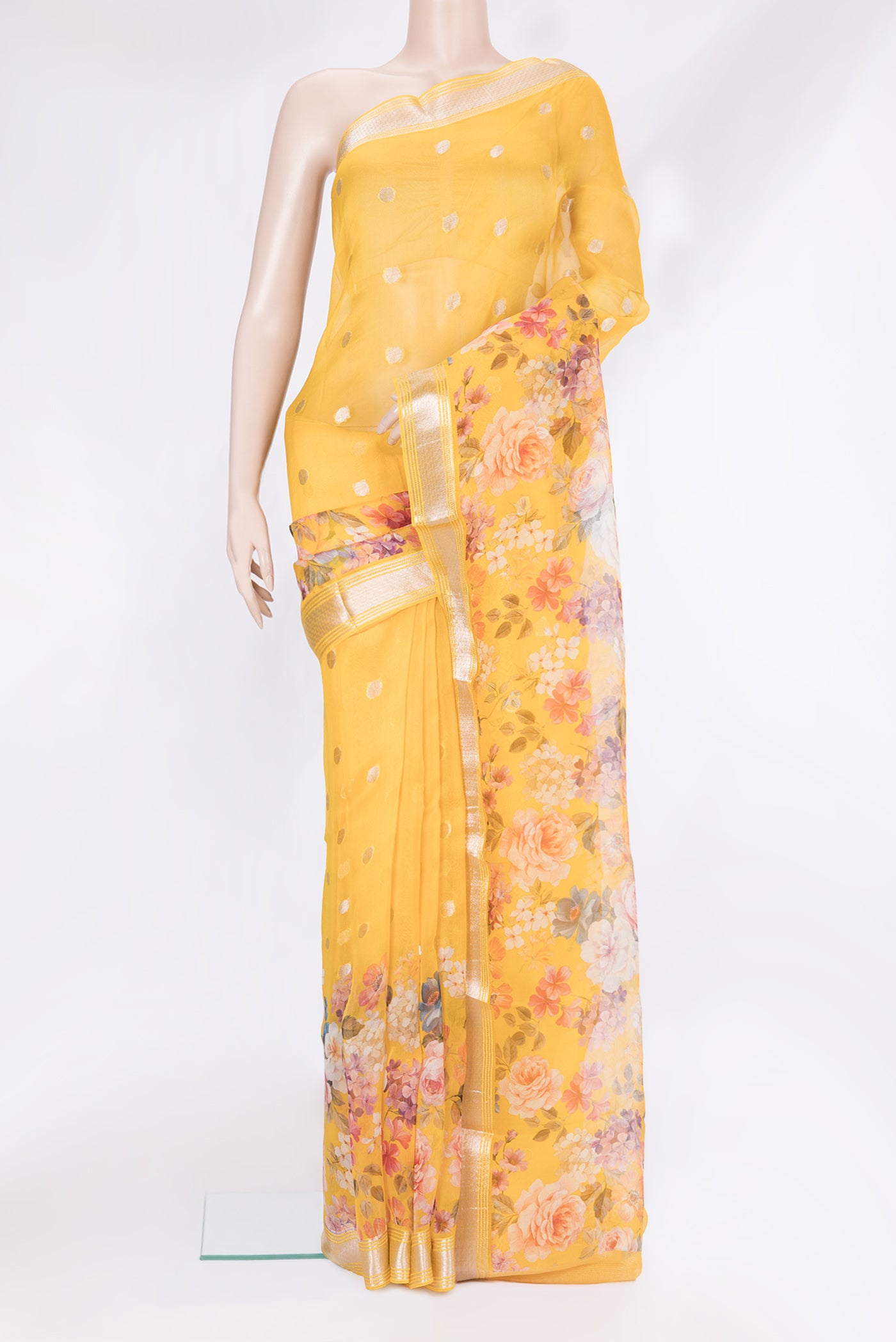Yellow Organza Silk Saree with Zari Butta on the body and Fancy Border.  displayed on a mannequin