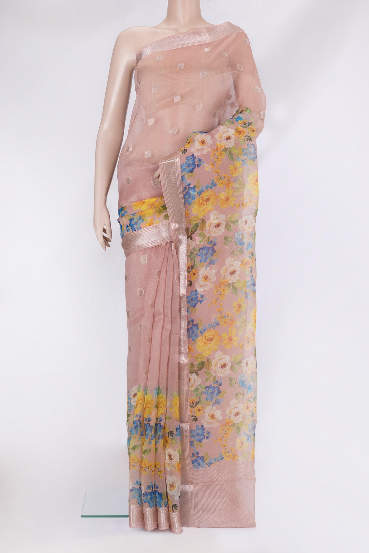 Rose Gold Organza Silk Saree with Zari Butta on the body and Fancy Border.  displayed on a mannequin