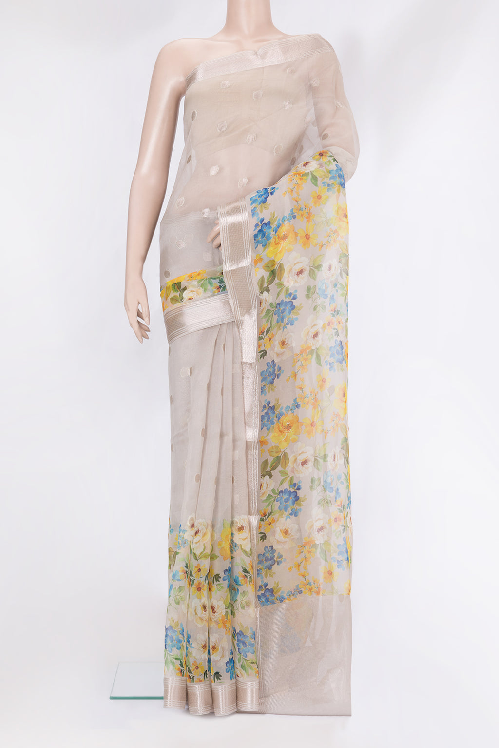 Beige Organza Silk Saree with Zari Butta on the body and Fancy Border.  displayed on a mannequin