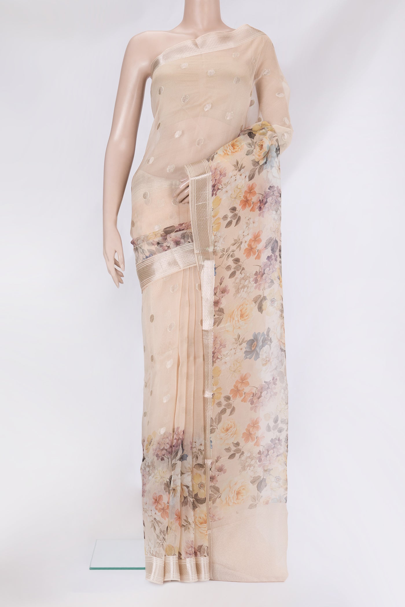 Beige Organza Silk Saree with Zari Butta on the body and Fancy Border.  displayed on a mannequin
